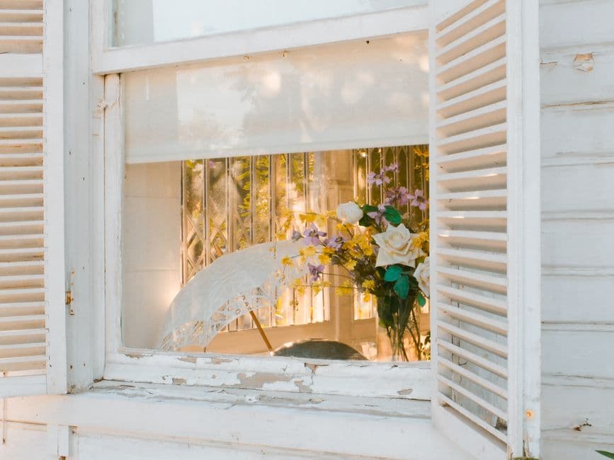 A quaint view through a window with a floral arrangement in İstanbul.