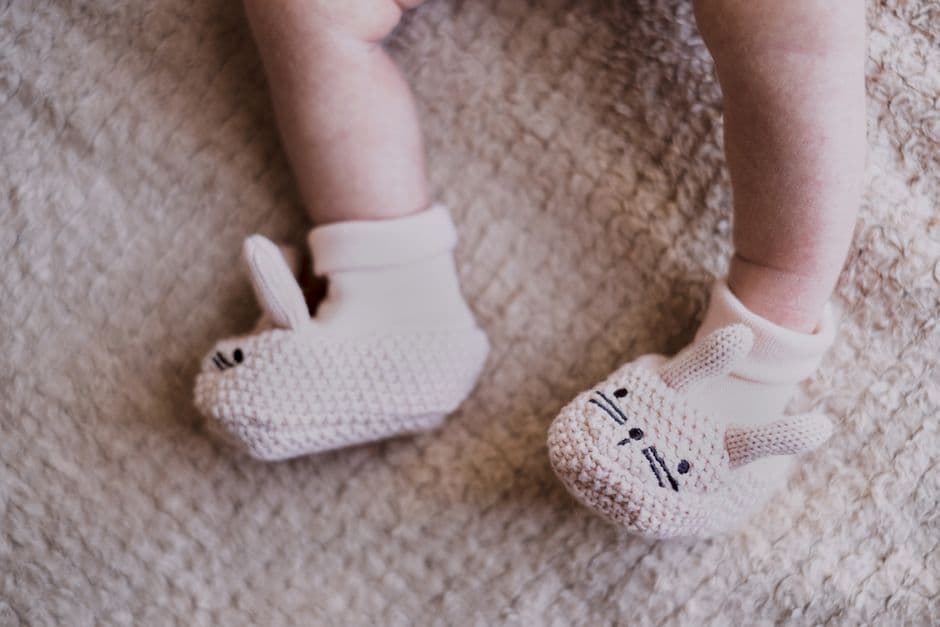 Cute knitted bunny booties on a newborn, perfect for Easter celebrations.